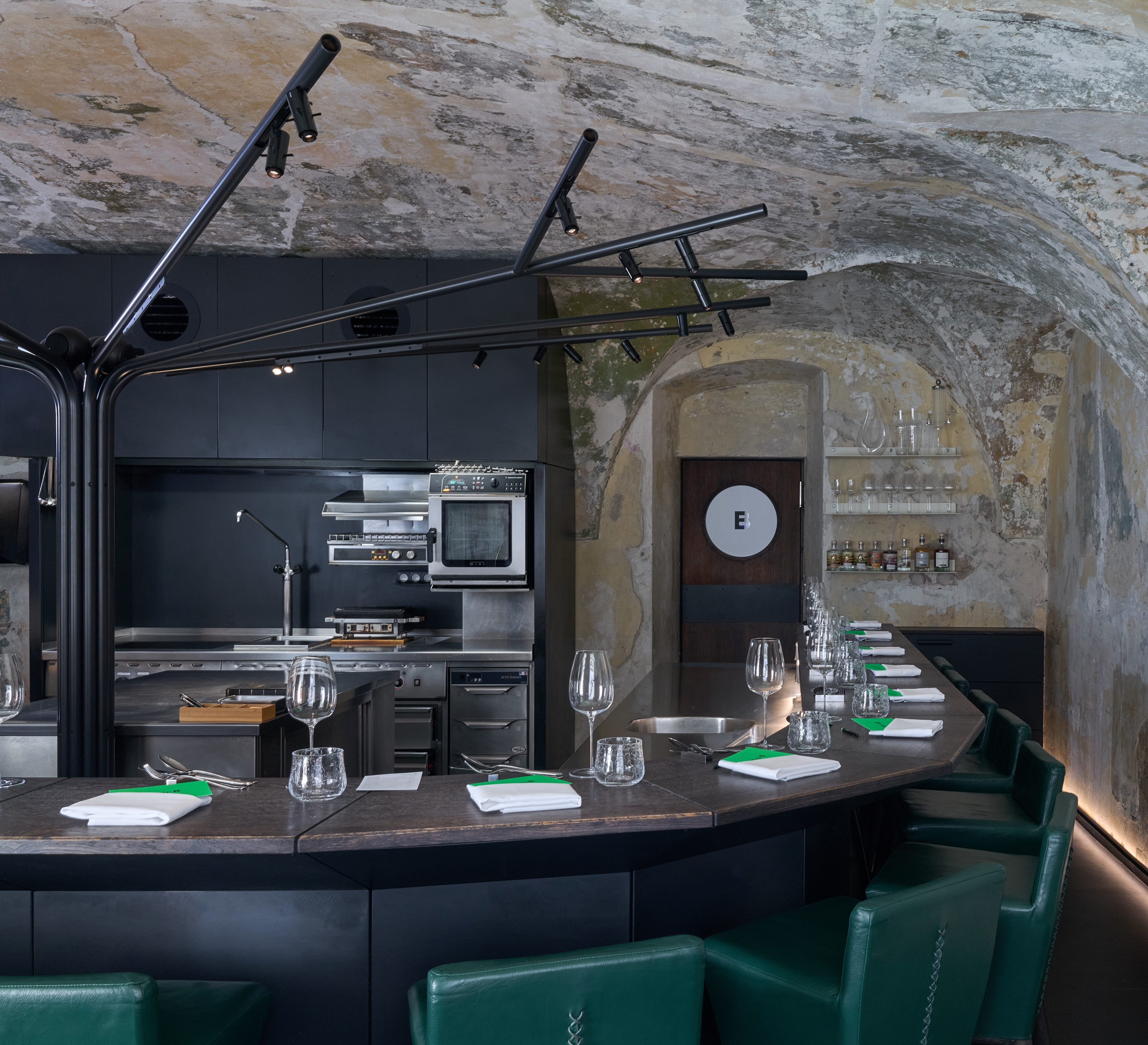 Interior of Marie B with an open kitchen and counter seating.