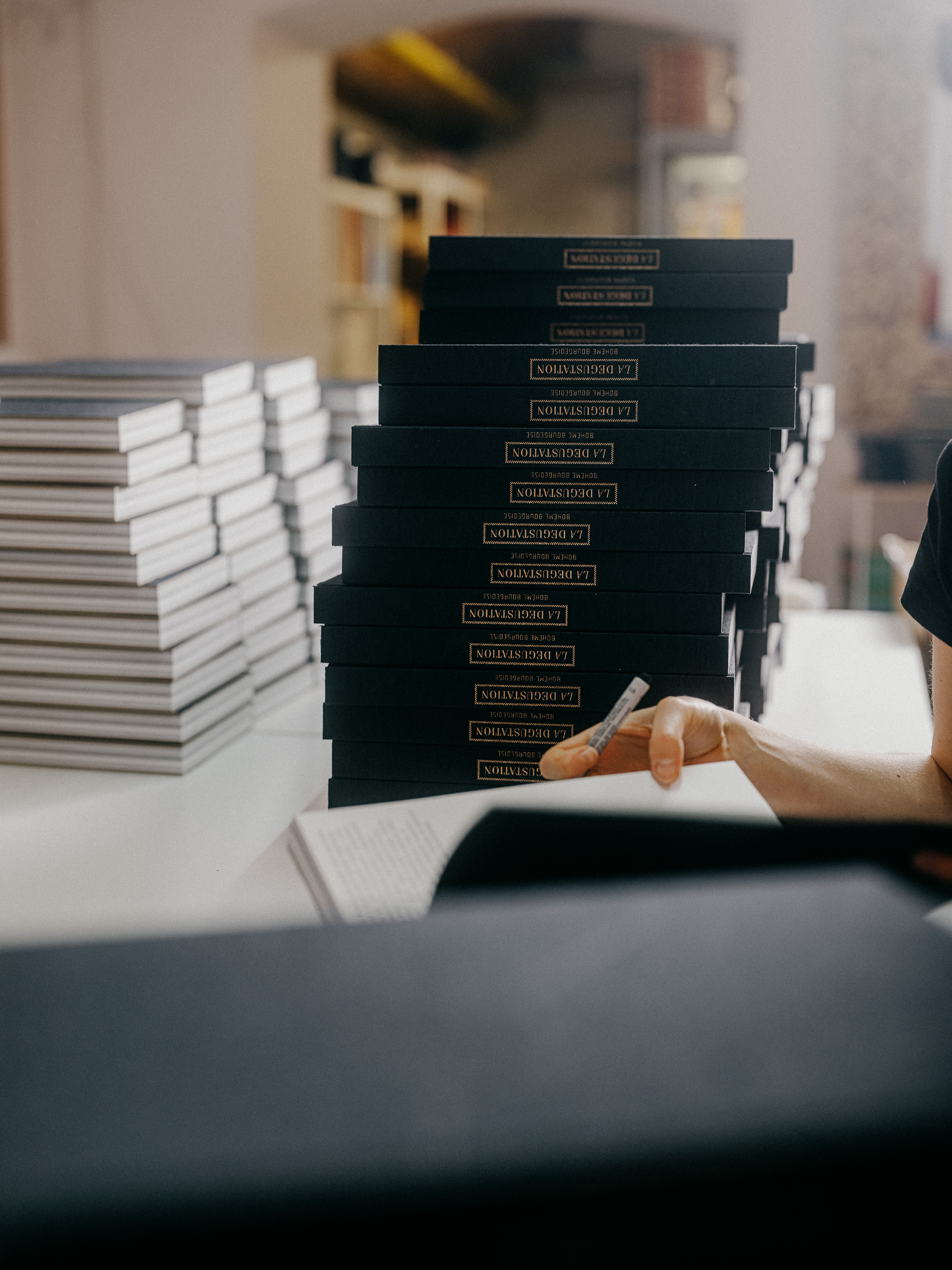 Preparing and assembling La Degustation Bohême Bourgeoise books.
