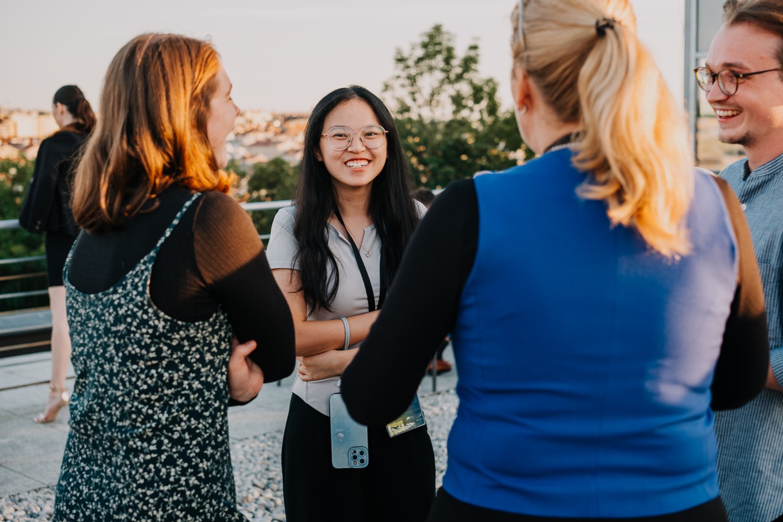 Students talking at a rooftop celebration