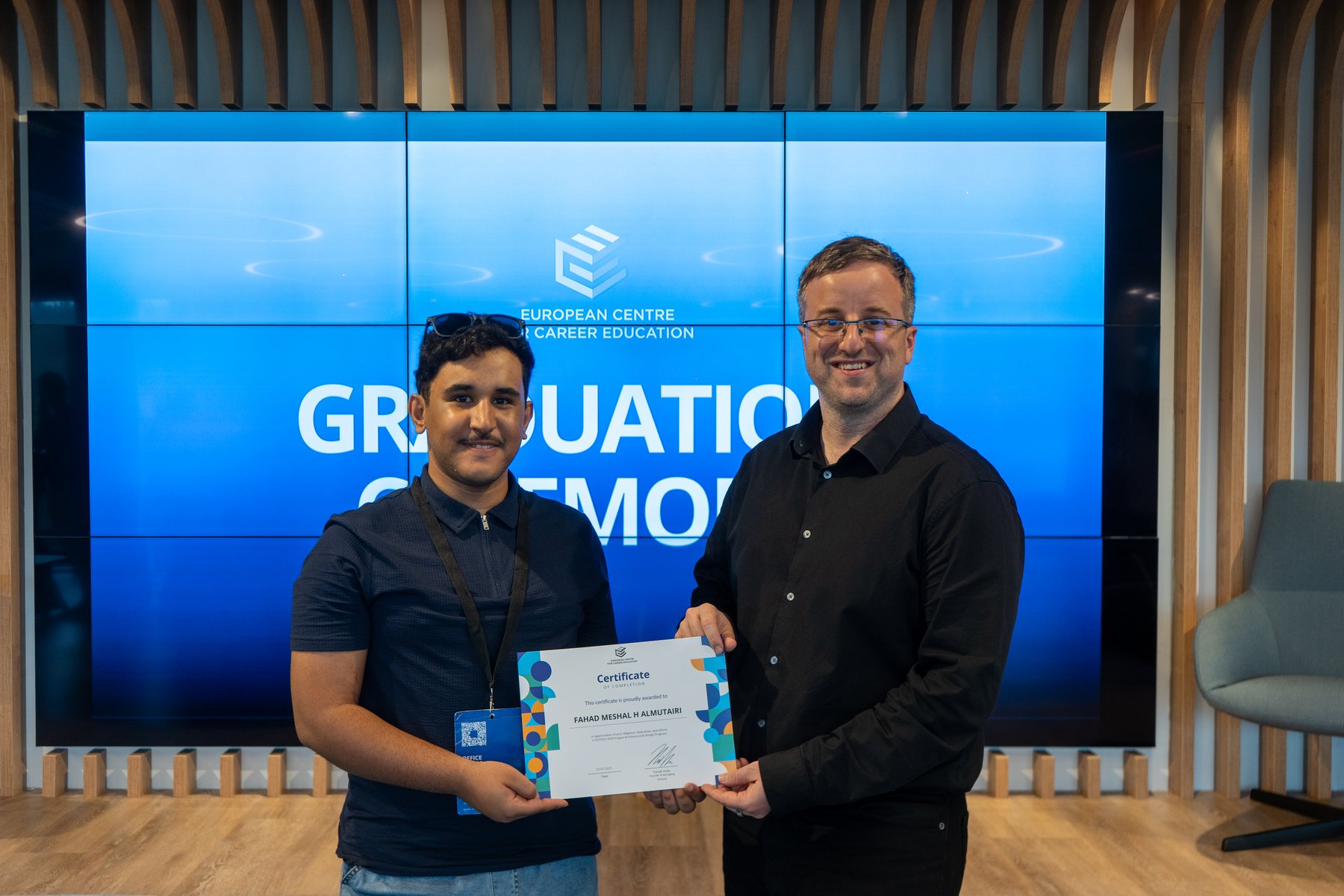 A student receiving their certificate at the graduation ceremony